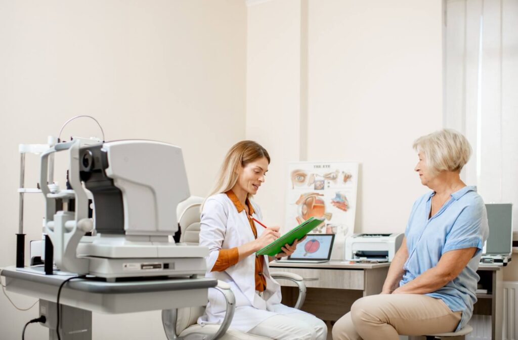 Optometrist consulting with an older woman during an eye exam appointment, reviewing notes and discussing results in a bright, modern eye care clinic.