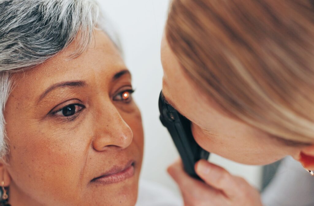 An eye doctor examing a patient during a slit lamp exam