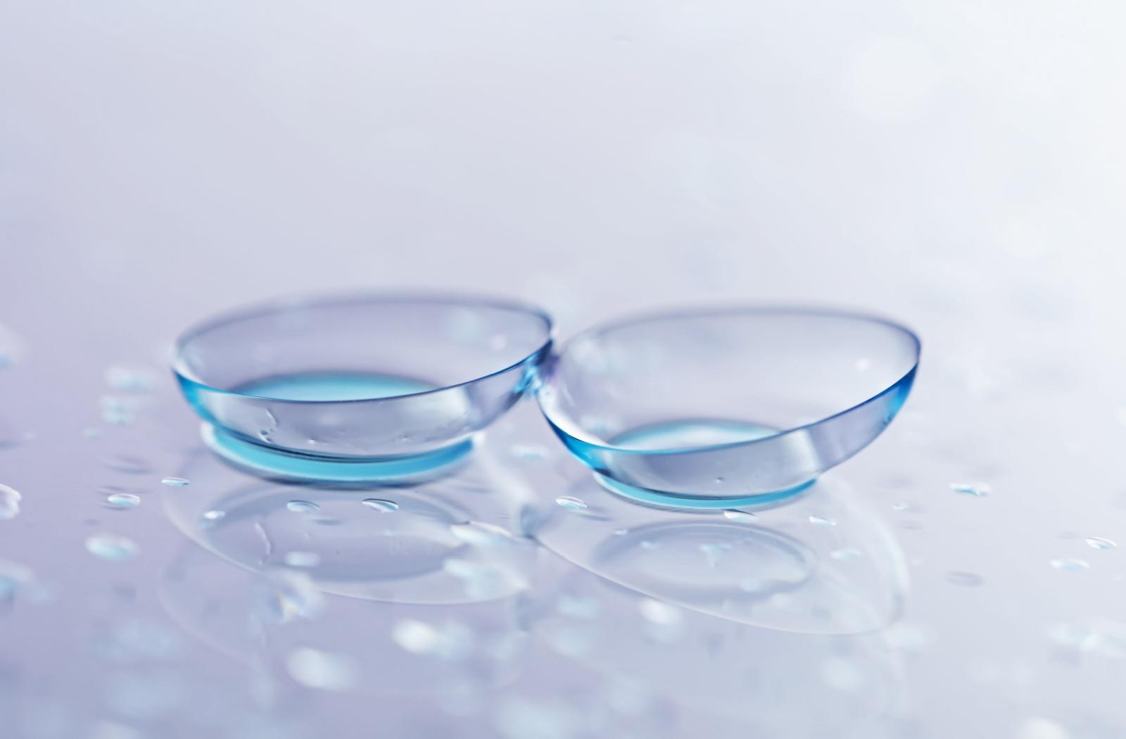 a pair of contact lens on a solid background.
