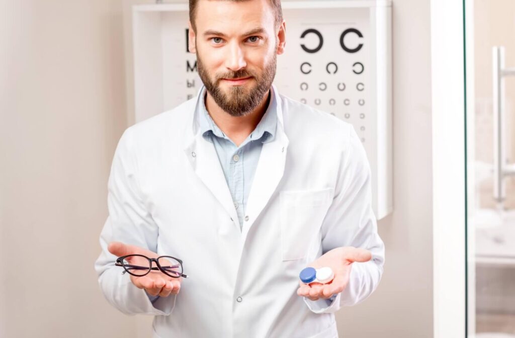 A man holding glasses in one hand and contact lens case in the other
